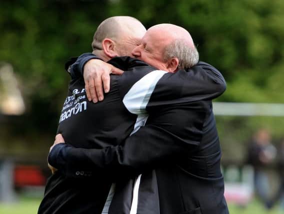 Ian Chapman and Kevin Newell hug after Sam Fisk's goal saved them from the drop