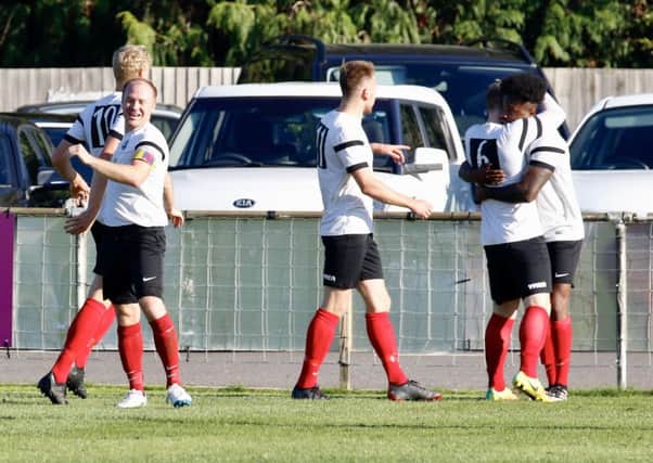 Horsahm YMCA celebrate Tony Nwachukwu's opening goal against Eastbourne Town on Saturday. Picture by Joe Knight