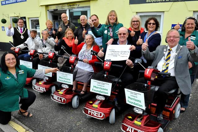 Alison Whitburn, community champion at Morrisons Littlehampton , presents Littlehampton Shopmobility with a cheque for the six new mobility scooters. Picture: Steve Robards SR1827811