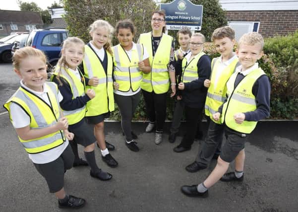 Storrington Primary School pupils wearing their new hi-vis vests donated by Barratt Homes SUS-181024-103349001