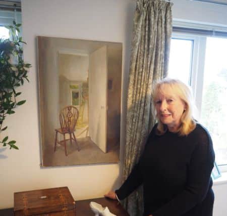 Jan with one of Gillian's paintings, showing a domestic scene