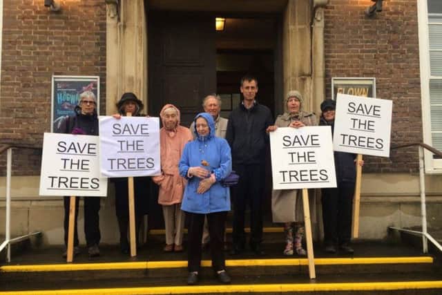 Worthing Society supporters gathered outside the town hall on Wednesday in protest against the felling of three sycamore trees as part of the Montague Centre plans SUS-160107-145006001