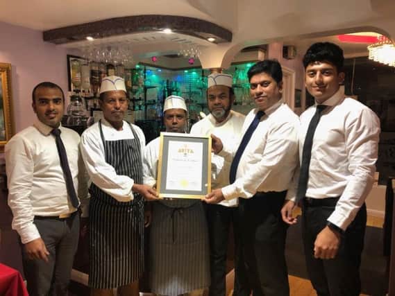 Staff at Bengal Brasserie with the award SUS-181030-112553001