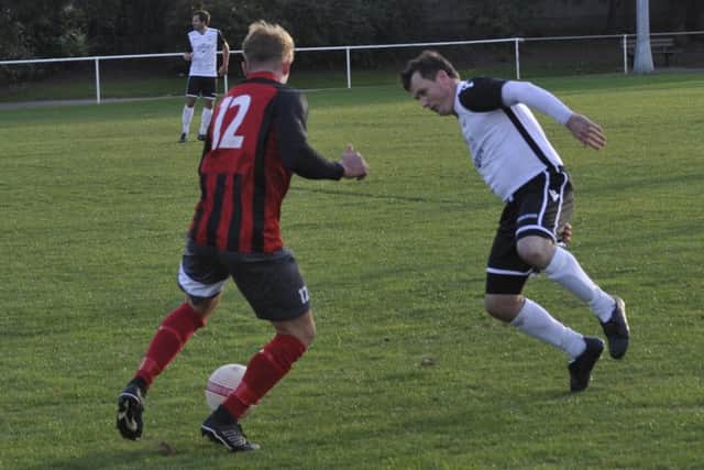 Bexhill United full-back Craig Ottley blocks the path of Wick substitute Guy Church