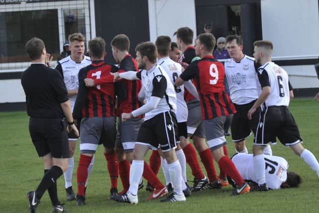 Tempers flare after the tackle by Jamie Cradock on Bexhill United full-back Chris Rea which earned the Wick midfielder a second yellow card