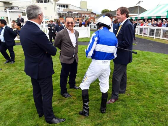 Vichai Srivaddhanaprabha pictured at Salisbury racecourse last month with connections including trainer Richard Hannon and jockey Ryan Moore / Picture: Malcolm Wells / Picture Exclusive.com