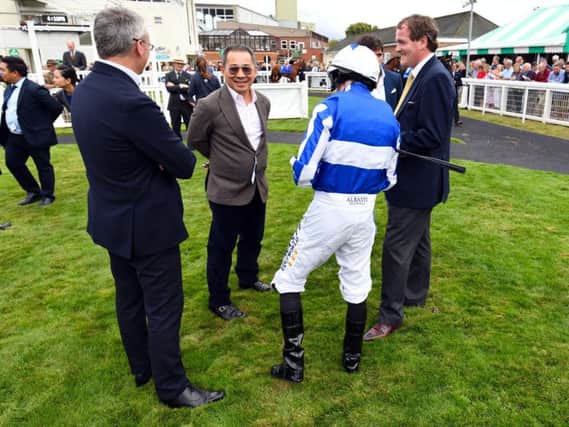 Vichai Srivaddhanaprabha with connections including trainer Richard Hannon and jockey Ryan Moore at Salisbury racecourse last month / Picture Malcolm Wells / Picture Exclusive.com