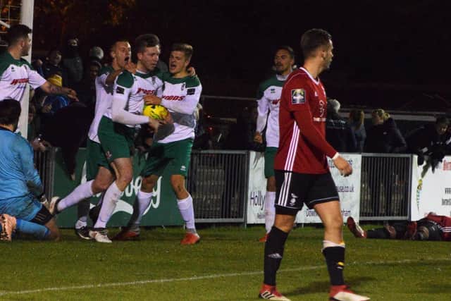 Jimmy Wild is mobbed after his late equaliser took the game to extra-time / Picture by Darren Crisp