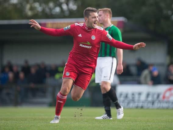 Ollie Pearce celebrates scoring against Burgess Hill on Saturday. Picture by Marcus Hoare