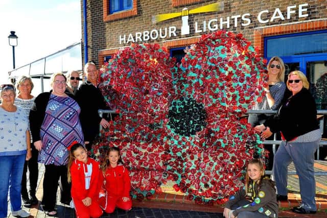 Volunteers with the poppy outside the Look & Sea Centre in Littlehampton