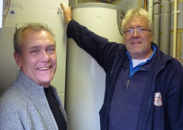 Gary and John Byrne from CJB plumbing at Rowleys Centre for the Community installing the new boiler thanks to a grant from the Community Foundation for Surrey SUS-180611-115452001