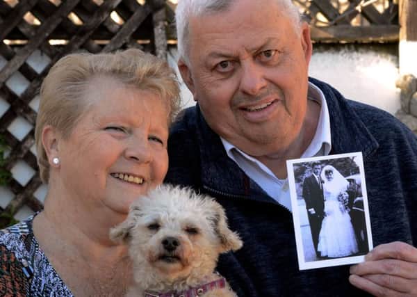 Roger and Janice Bullen with their dog Pippa, and a photo of them on their wedding day. Picture: Kate Shemilt