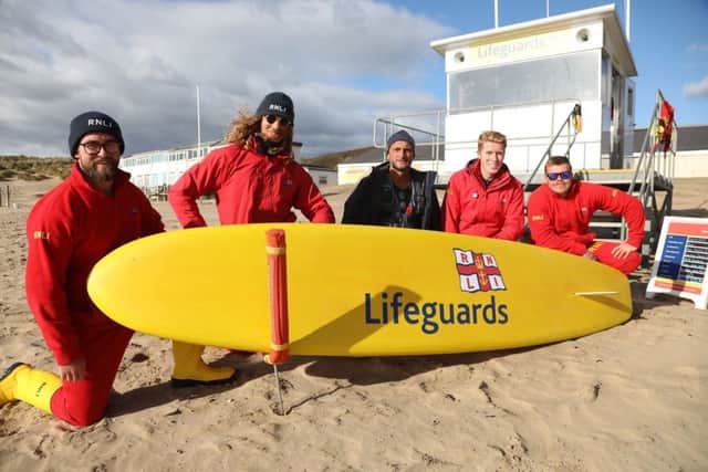 Lifeguards at Camber with Rob Cass (centre), coastal officer for the beach. Photo by Kt Bruce SUS-181031-171809001