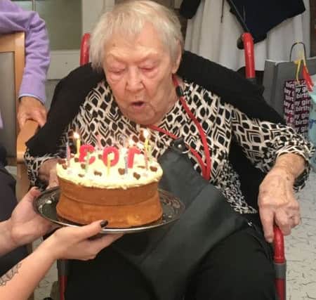 103-year-old Hove resident Kathleen Dilley blows out her birthday candles