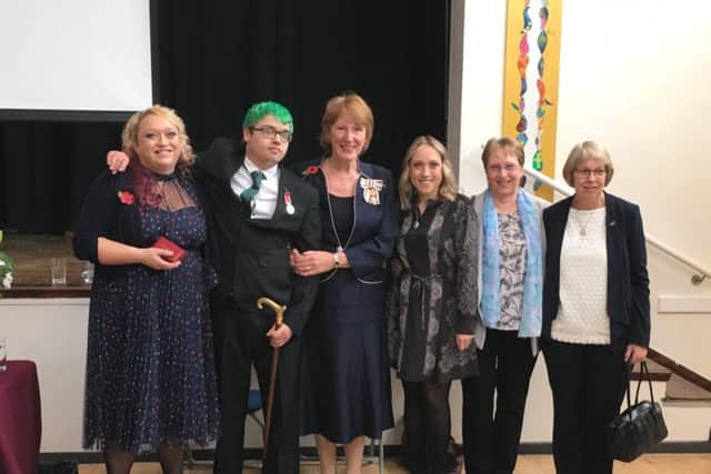 Tyler Murphy, pictured with his mum Jan Ellis (left) and the Lord Lieutenant of West Sussex, Susan Pyper (centre) and others gathered for the investiture ceremony.