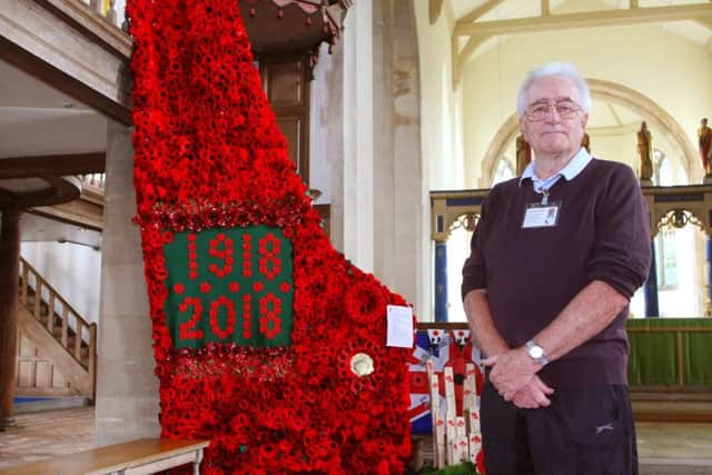 DM18100036a.jpg. Poppy cascade created from more than 2,000 knitted, felt and plastic poppies in St Mary's Church, Littlehampton. Terry Elderfield, deputy organiser. Photo by Derek Martin Photography SUS-180410-122734008