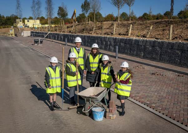 Prefects at the March CE School in Westhampnett inspect the new school car park built by Rolls-Royce. November 2018.