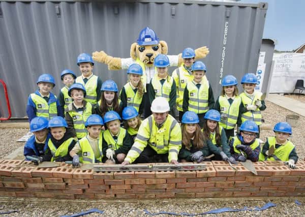 The children from Lindfield Primary with the site's mascott learning about site safety