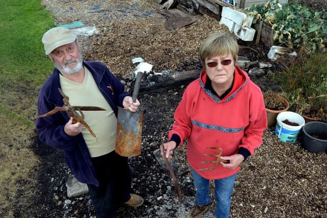 Stewart and Pat Clarke standing on the remains of their shed which was burnt to the ground. ks180547-2