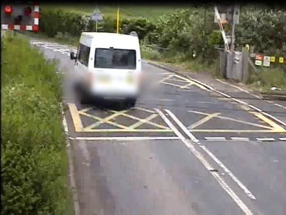 Video footage from the level crossing shows vehicles crossing while the barriers are closing. Source: Network Rail