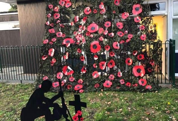 An art display created from an army camouflage net, handcrafted poppies and a silent soldier silhouette have formed the centrepiece of Singleton school's
Remembrance Day commemoration. Picture contributed