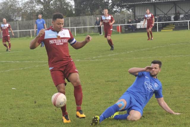 Little Common midfielder Wes Tate is tackled by Shoreham's Scott Kirkwood