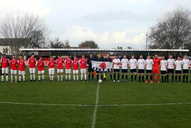 Pagham and Peacehaven line up for the pre-match minute's silence / Picture by Roger Smith