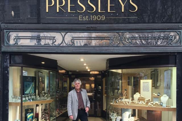 Neville Pressley outside the shop