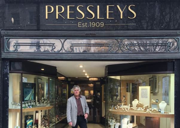 Neville Pressley outside the shop