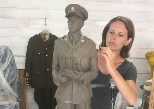 Artist Hannah Stewart with a clay model of the sculpture of Captain Wilfred 'Billie' Nevill