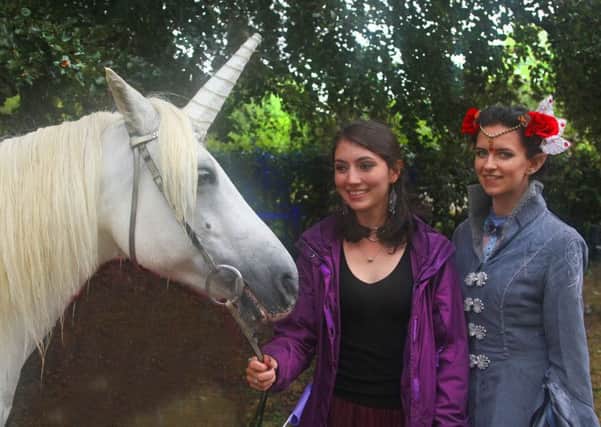 Rosanna Long  and Emily Barnes and an enchanted unicorn in Horsham Park this summer. Photo by Derek Martin Photography. SUS-180730-002056008