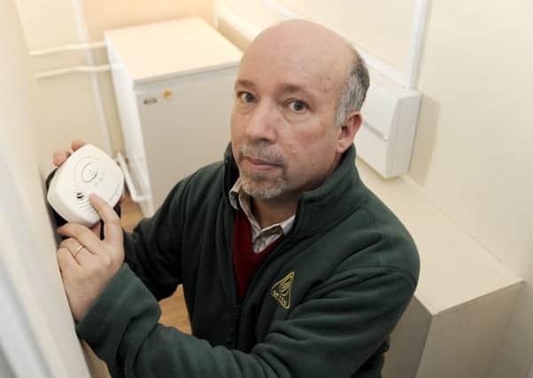 Malcolm Farrow of OFTEC checks his carbon monoxide detector