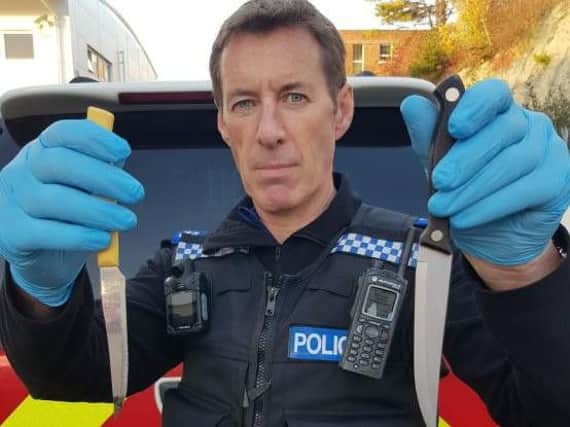 A PSCO holding the hidden knives. Photo: Brighton and Hove Police / Twitter