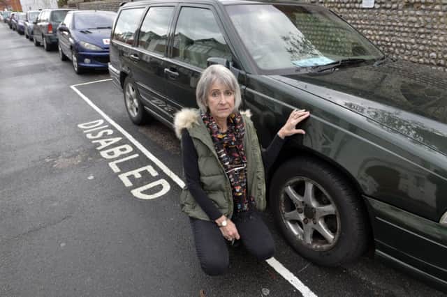 Cheryl West next to her and her husband's car in Hanover Road, Eastbourne (Photo by Jon Rigby)