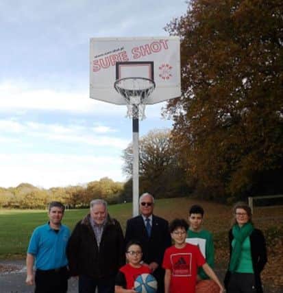 From left: Adrian Gaylon, Rother's sports development officer; Cllr JIm Carroll, Rother's cabinet member for young people, sport and leisure; Dave Miles president of the Rotary Club of Senlac; and Rebecca Owen, Rother's parks development officer, with keen basketball player Rueben, who requested the goals, and his brothers Stanley and Eli SUS-181114-151929001