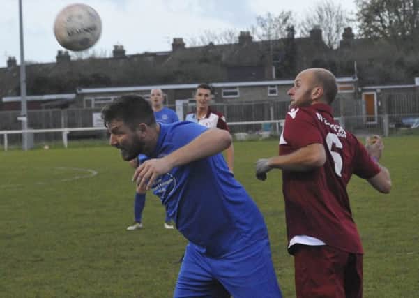 Little Common player-manager Russell Eldridge challenges Shoreham forward Ryan McBride during last weekend's 2-2 draw. Picture by Simon Newstead