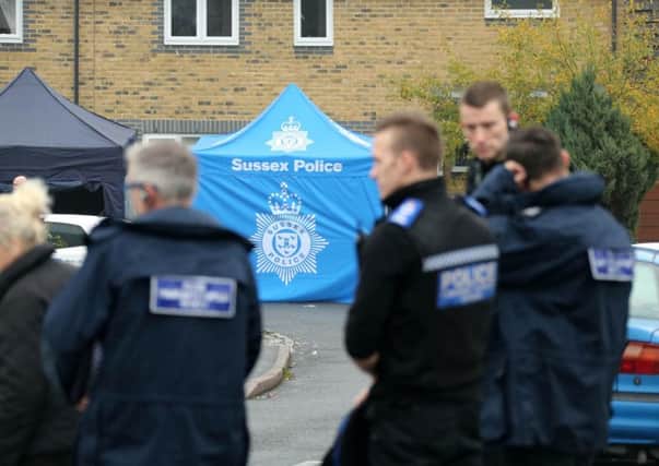 Police at the scene of a fatal stabbing in Crawley