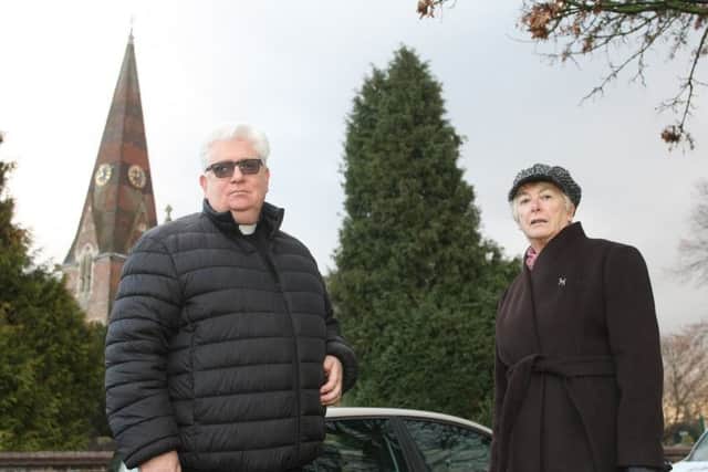 Father Kevin O'Brien and Burgess Hill Town Council leader Pru Moore next to the giant tree outside St John's Church. Photo by Derek Martin Photography