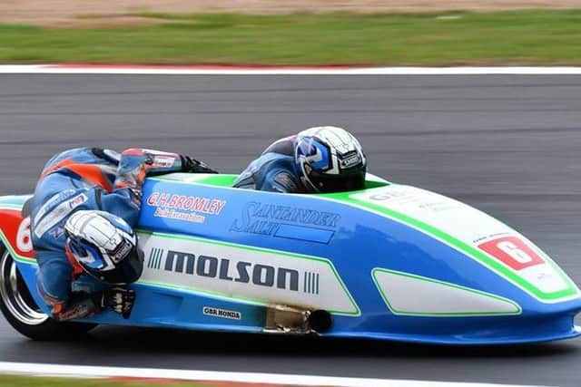Charlie Richardson (back) leans into the corner with driver Todd Ellis at Brands Hatch