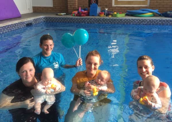Puddle Ducks teacher Claire Turner with little swimmers are their parents at Hilton Avisford Park