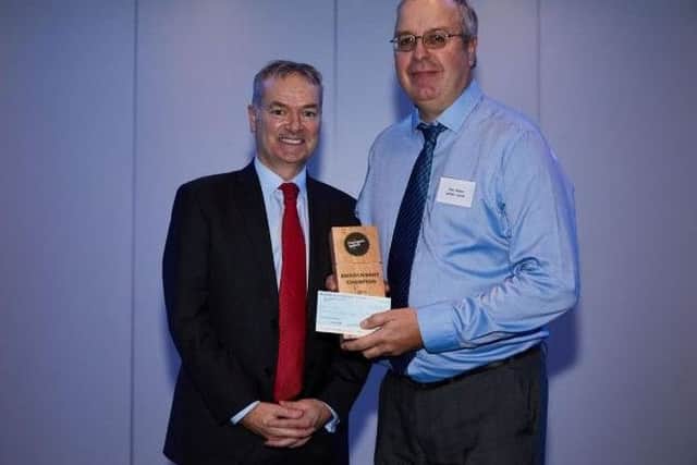 Stagecoach Group chief executive Martin Griffiths presenting Alan Winter with his gold Environment Champion award