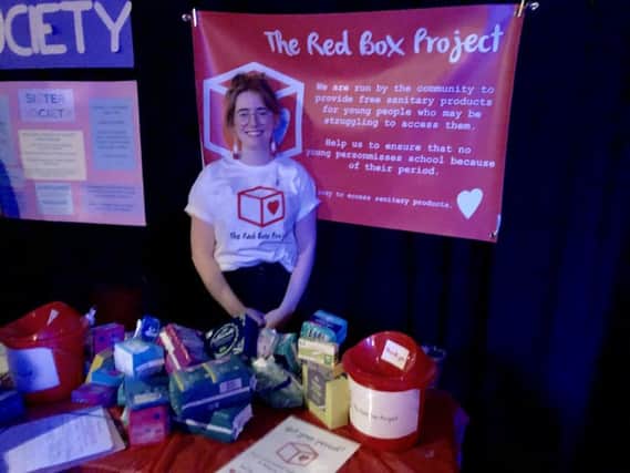 Bramble Wallace, co-ordinator of the Red Box Project in Brighton, overseeing the fundraiser stall
