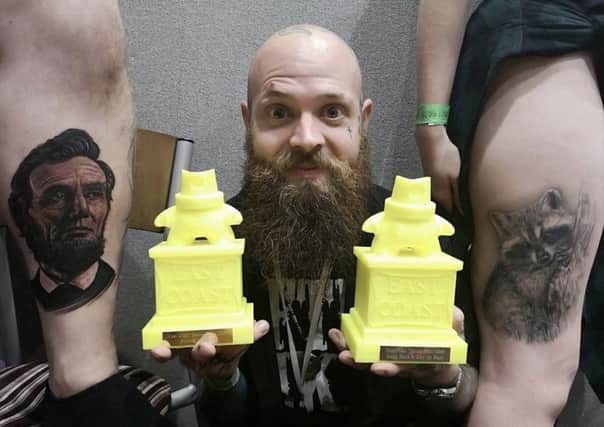 Lee Uttley with his two award winning tattoos