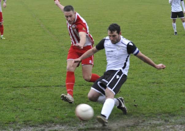 Bexhill United captain Craig McFarlane tries to keep the ball in play during the 1-0 defeat at home to Steyning Town. Pictures by Simon Newstead