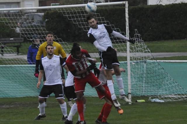 Bexhill United full-back Nathan Lopez gets his head to a long Steyning throw