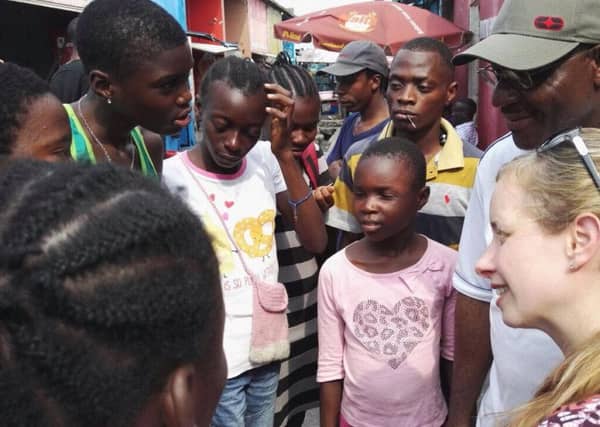 Stephanie Mooney, far right, talking to street-living children in Kinshasa, DR Congo