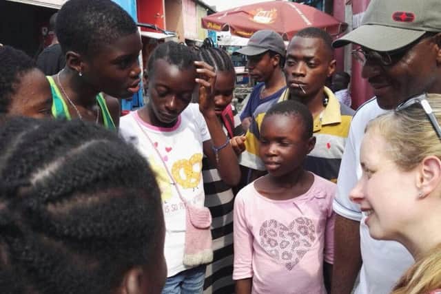 Stephanie Mooney, far right, talking to street-living children in Kinshasa, DR Congo