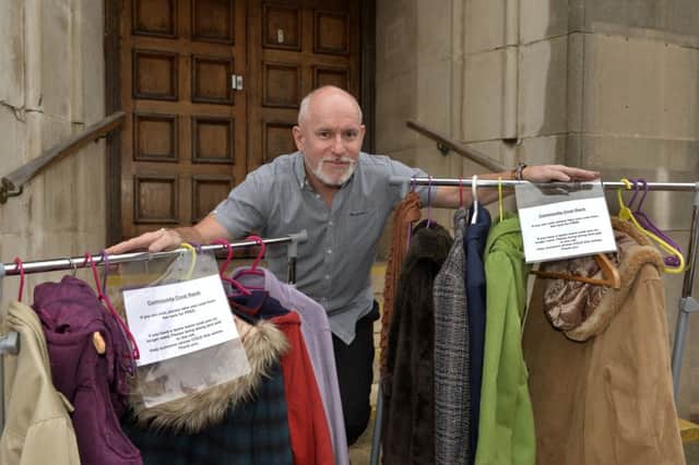 Gary Young owner of The Grove Experience next to the coat rails he has set up for homeless people (Photo by Jon Rigby)