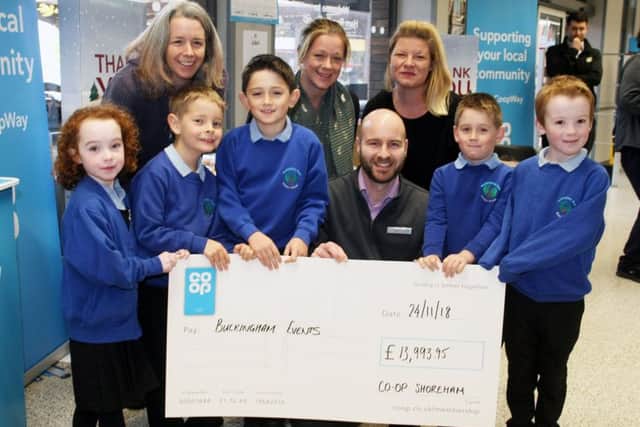 Store manager Paul Coote presents the cheque to Buckingham Events for Buckingham Park Primary School. Photo by Derek Martin DM18112835a