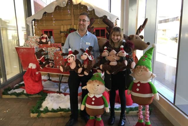 Mark Lephard, assistant manager at Haskins Roundstone Garden Centre, presenting reindeers to 11-year-old Lucy Croke, a student at The Angmering School